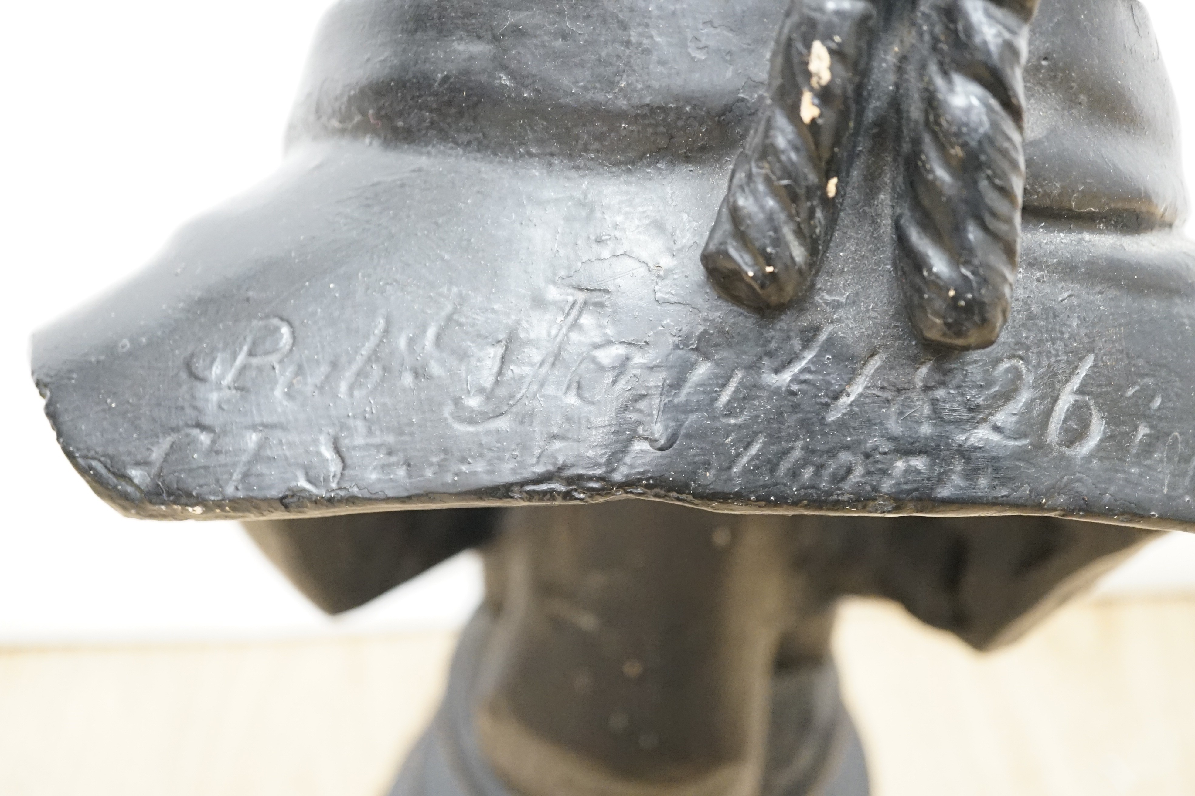 A black painted plaster bust of a judge, inscribed 1826, 49cms high.